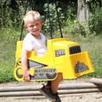 young boy on the bulldozer toddler swing